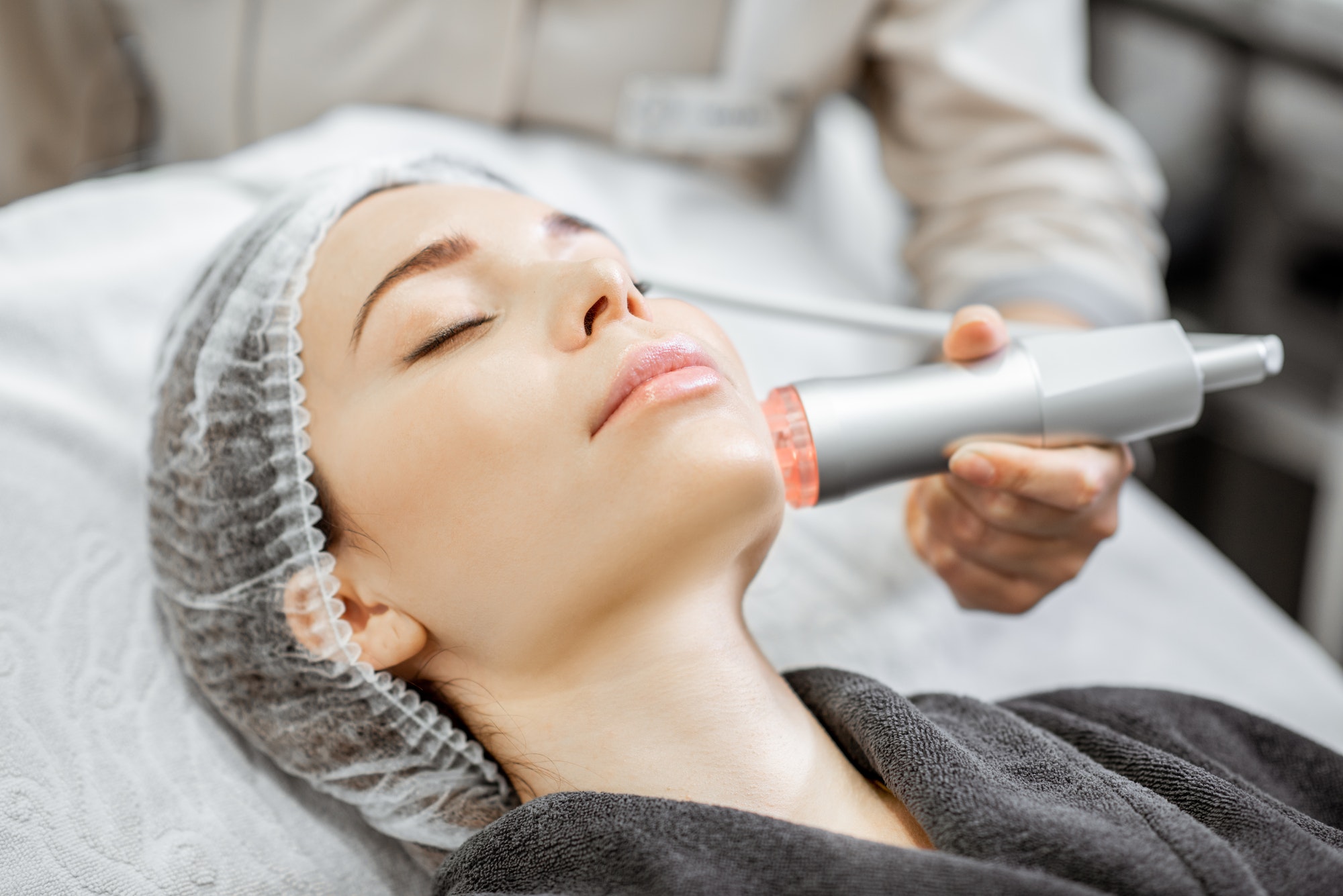 Woman during the facial treatment at the beauty salon